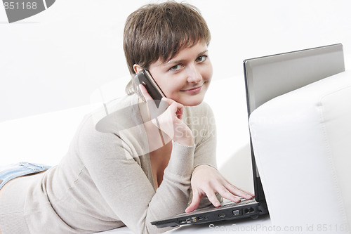 Image of Woman with phone on sofa