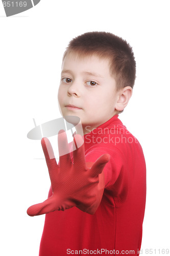 Image of Boy in red rubber gloves gesturing stop