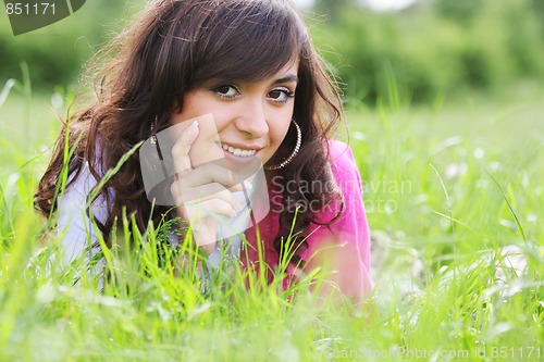 Image of Brunette in white laying in grass