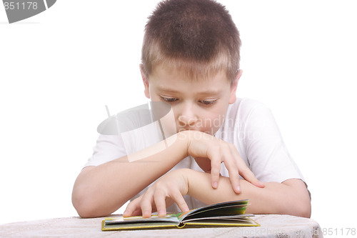 Image of Boy reading book at table