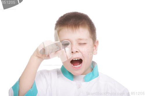 Image of Boy looking through magnifying glass