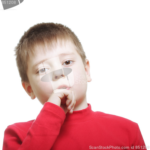 Image of Serious boy in red leaning on fist