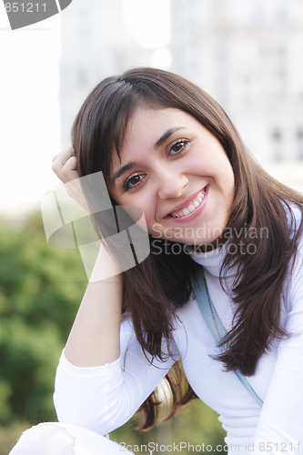 Image of Smiling woman leaning on hand