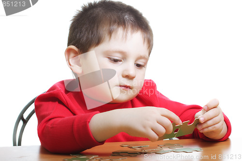 Image of Boy assembling green puzzles