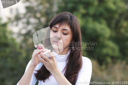 Image of Brunette outdoors with makeup set