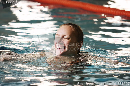 Image of Happy woman in swimming pool