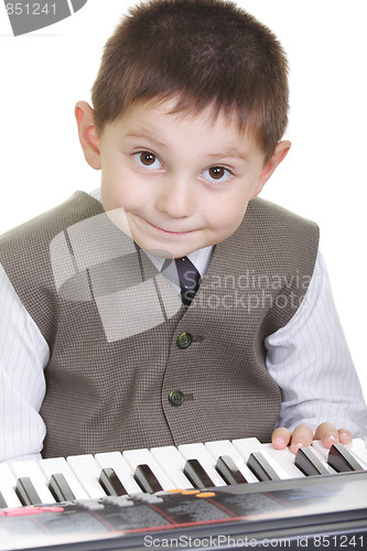 Image of Cute kid at piano keyboard