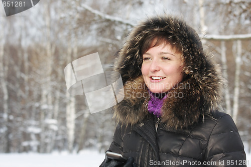 Image of Smiling woman with phone in hand