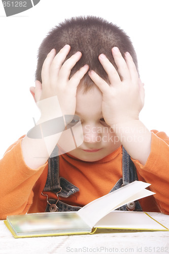 Image of Pensive kid reading book