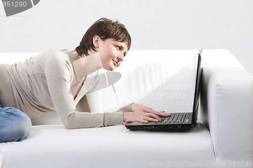 Image of Woman on sofa looking to monitor