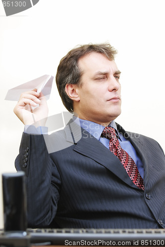 Image of Serious businessman aiming plane