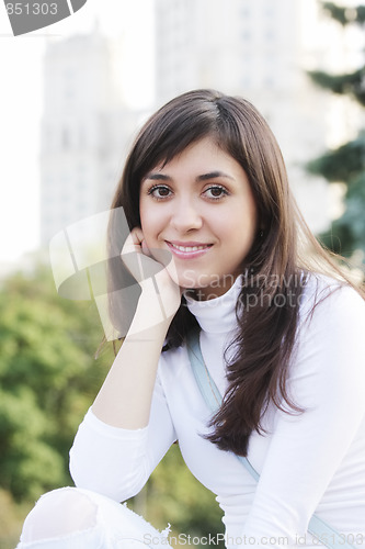 Image of Smiling woman in white blouse