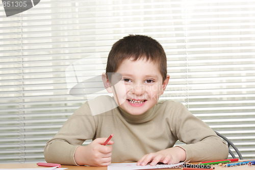Image of Smiling boy with red pencil