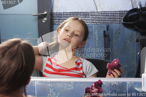 Image of Girl preening at mirror