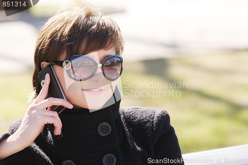 Image of Smiling woman in black with cellphone