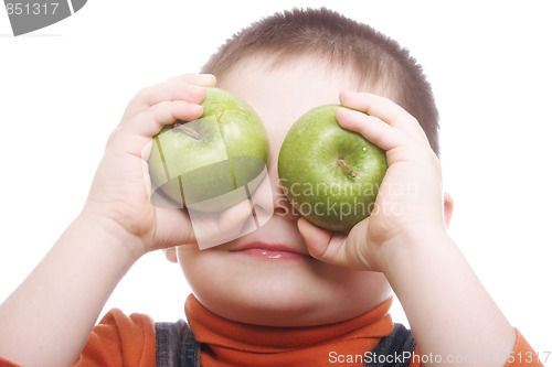 Image of Boy shutting eyes with apples