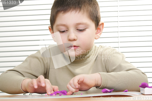 Image of Kid modelling plasticine sculpture