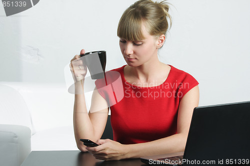 Image of Businesswoman in red reading message