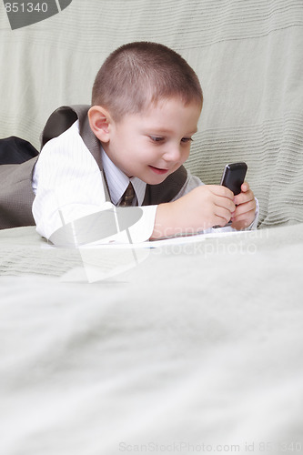 Image of Little boy looking at cellphone