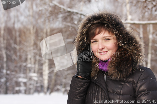 Image of Smiling woman on phone in frosty day