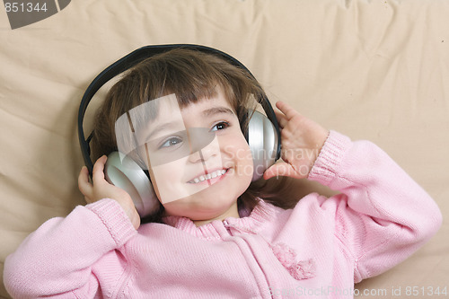 Image of Smiling girl enjoying music