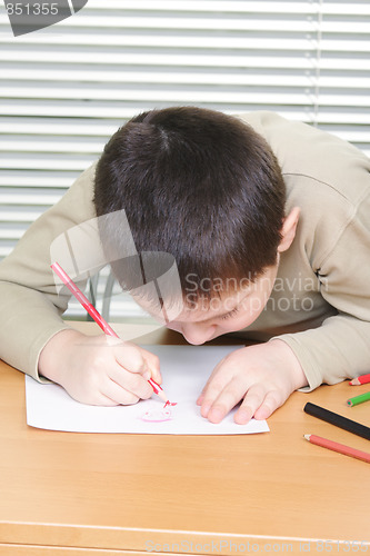 Image of Boy inclining over drawing