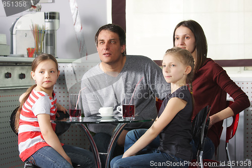 Image of Family in cafe looking aside
