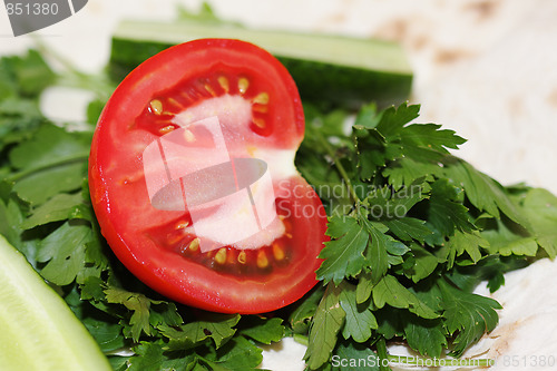 Image of Sliced tomato on greens