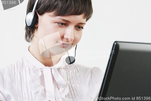 Image of Businesswoman with headset at computer