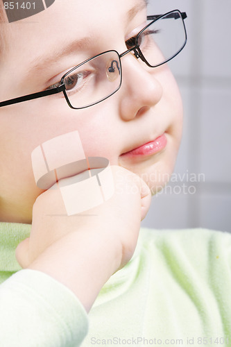 Image of Thoughtful boy leaning on fist
