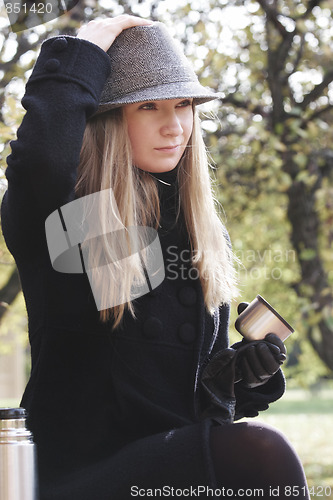 Image of Woman in black coat and hat