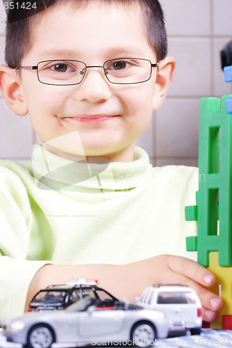 Image of Smiling boy with toys