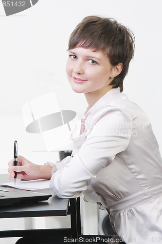Image of Pretty businesswoman at desk