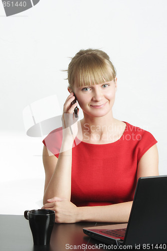 Image of Businesswoman in red on cellphone