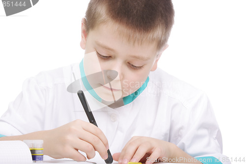 Image of Boy examining object in lab