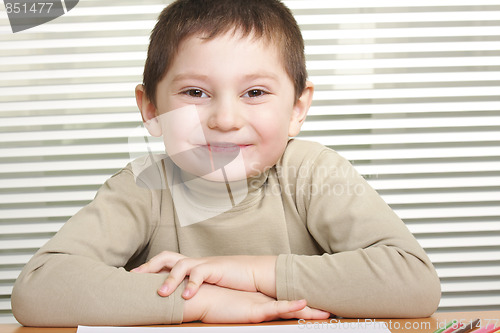 Image of Smiling boy at desk