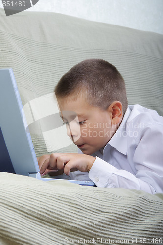 Image of Boy typing on laptop