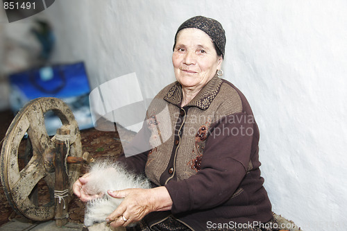 Image of Senior woman carding woollen yarn