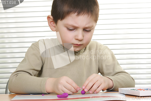 Image of Boy modelling at desk