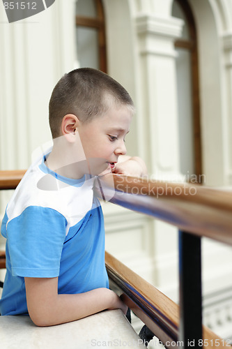 Image of Boy at banister looking down