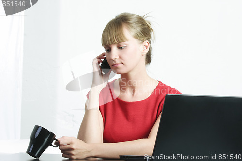 Image of Businesswoman in red on cellphone