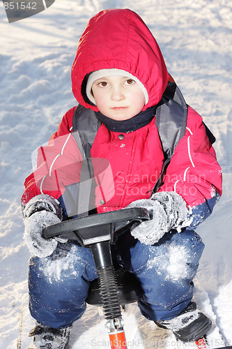 Image of Serious boy on sledge