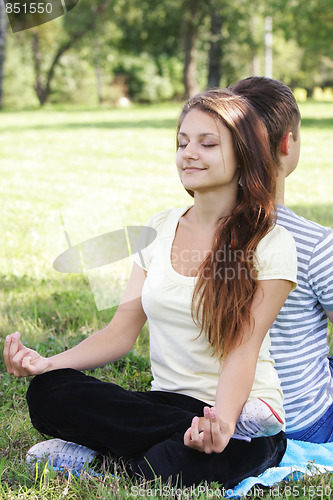 Image of Contented woman relaxing in yoga pose