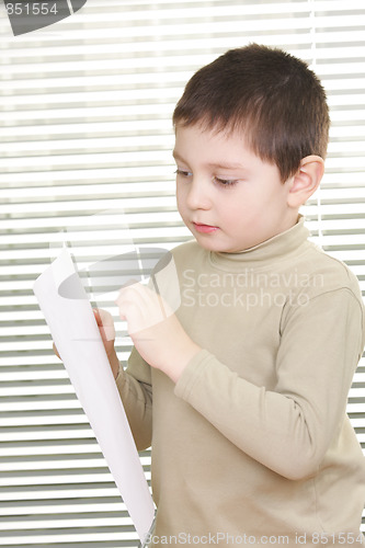 Image of Boy standing with blank paper