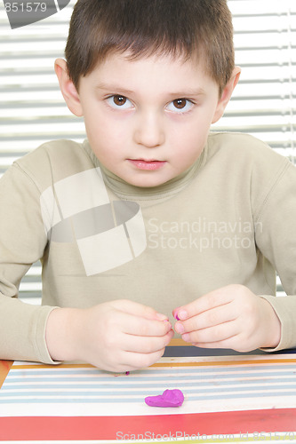 Image of Little boy with plasticine