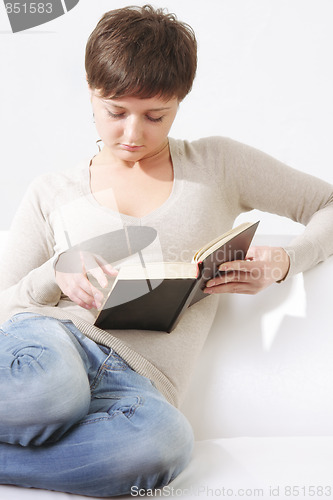 Image of Woman reading book on sofa closeup