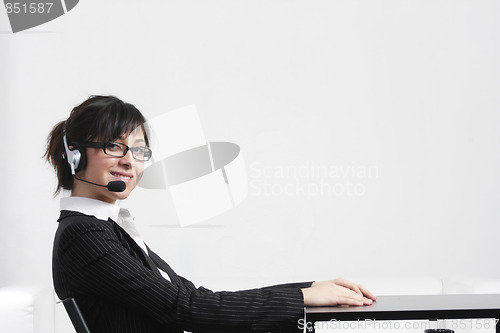 Image of Businesswoman sitting at desk sideview