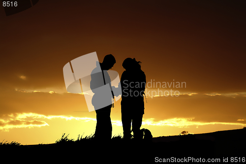 Image of Two people silhouetted against dramatic skyline