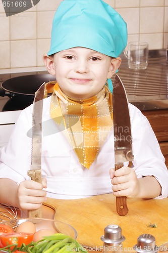 Image of Smiling cook with two knives