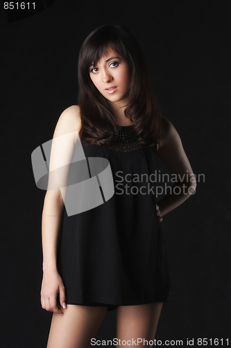 Image of Young woman in black short dress